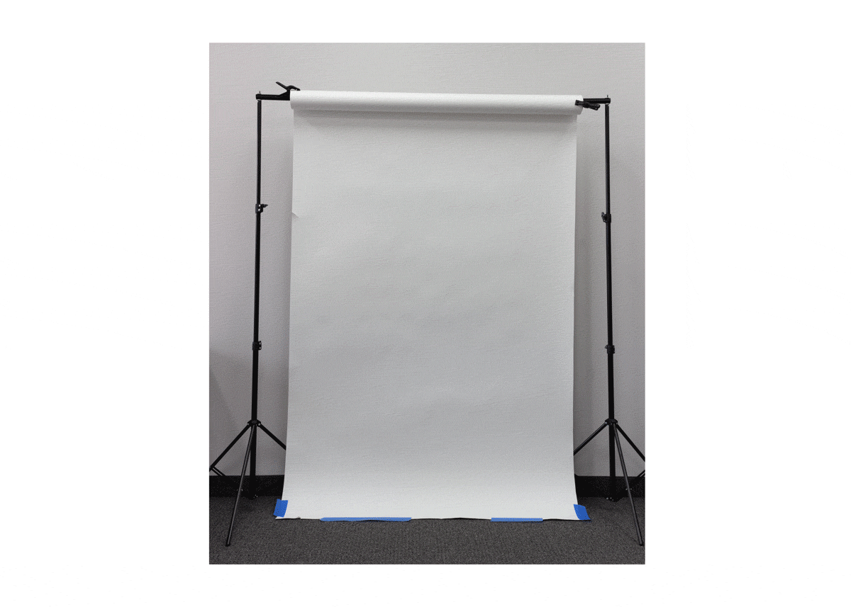 A paper roll backdrop being rolled up and down